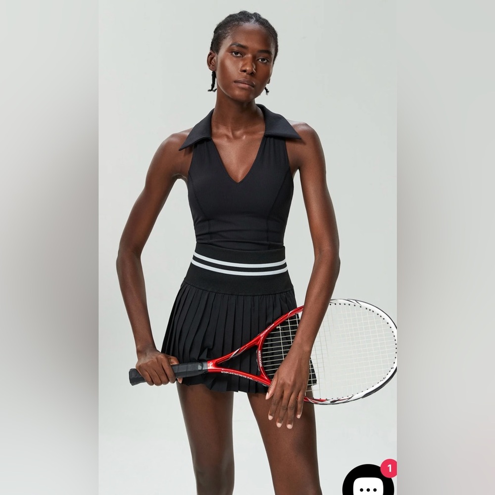 Black tennis or golf skirt and racer back tank set.  Size L NWT